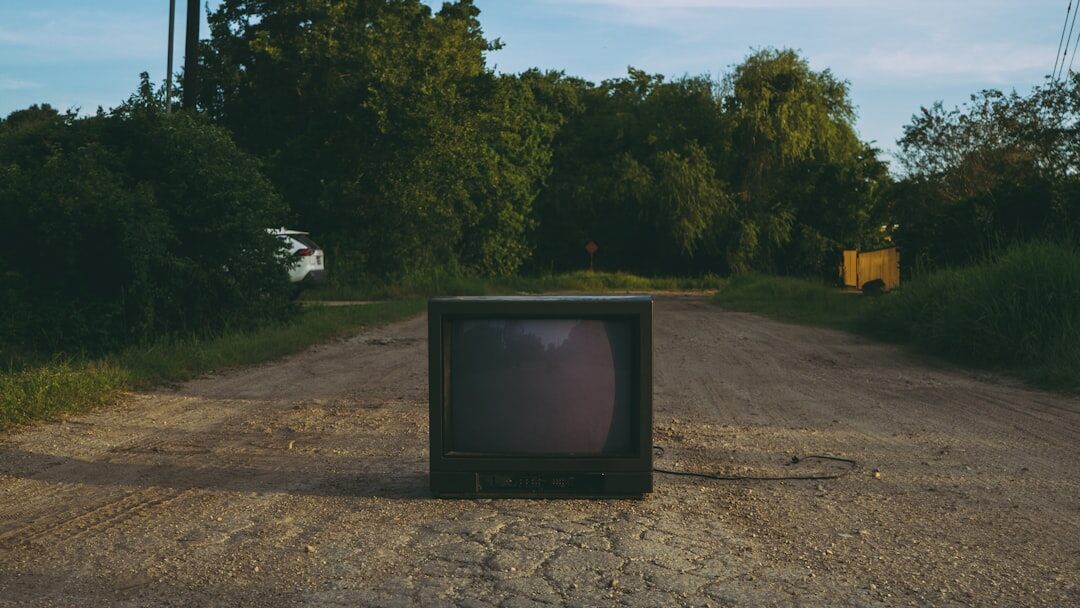 Vintage television set displaying a colourful advertisement in a 1980s living room